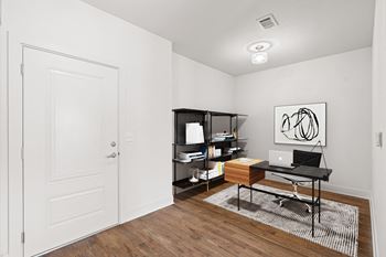 A room with a desk, laptop, and bookshelf. at Mirabelle Luxury Apartments, Missouri, 64111
